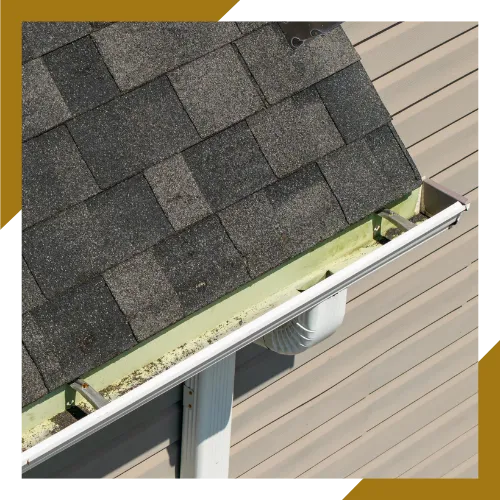 Clogged gutters filled with leaves and debris before service