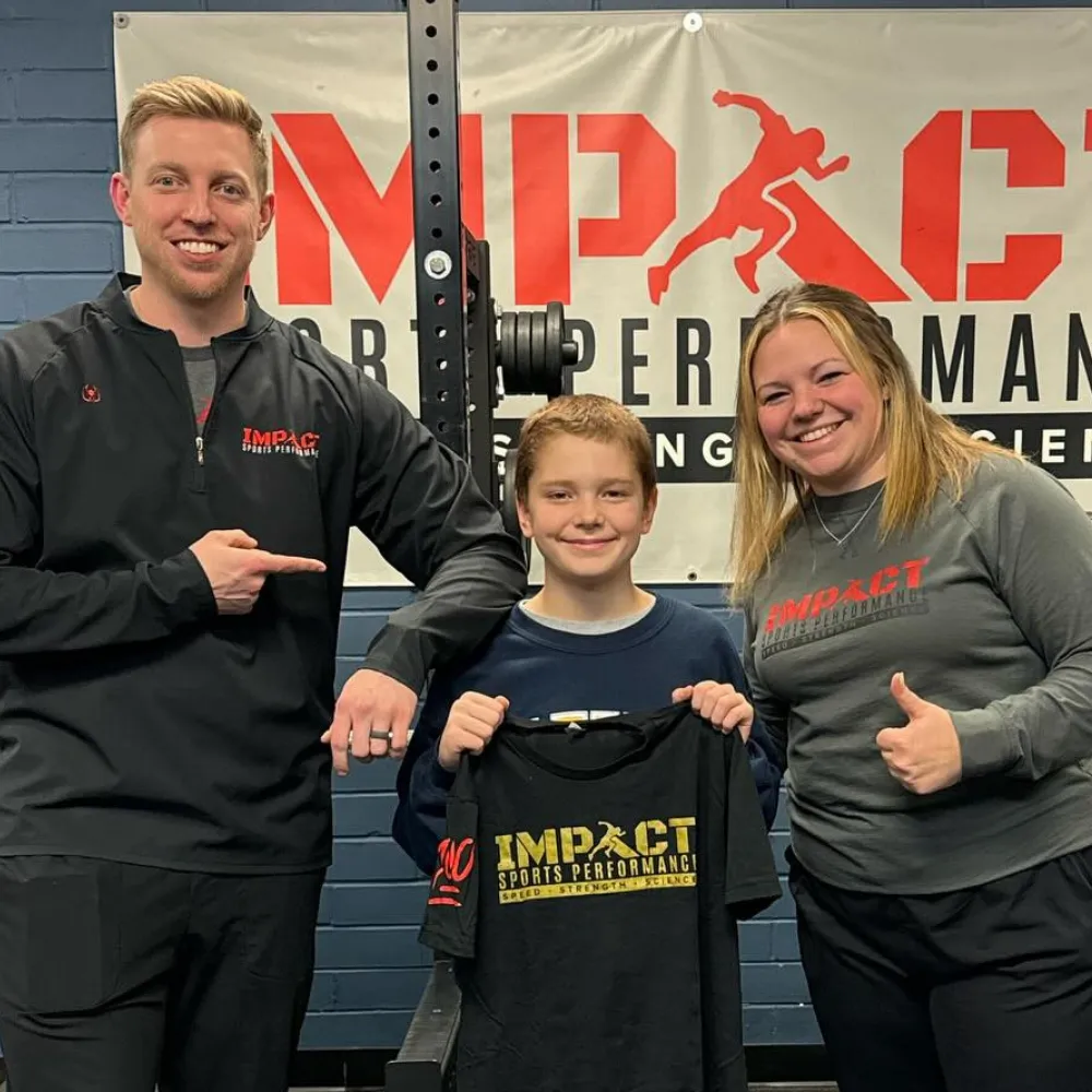 Young athlete and coach celebrating first training session at Impact Sports Performance