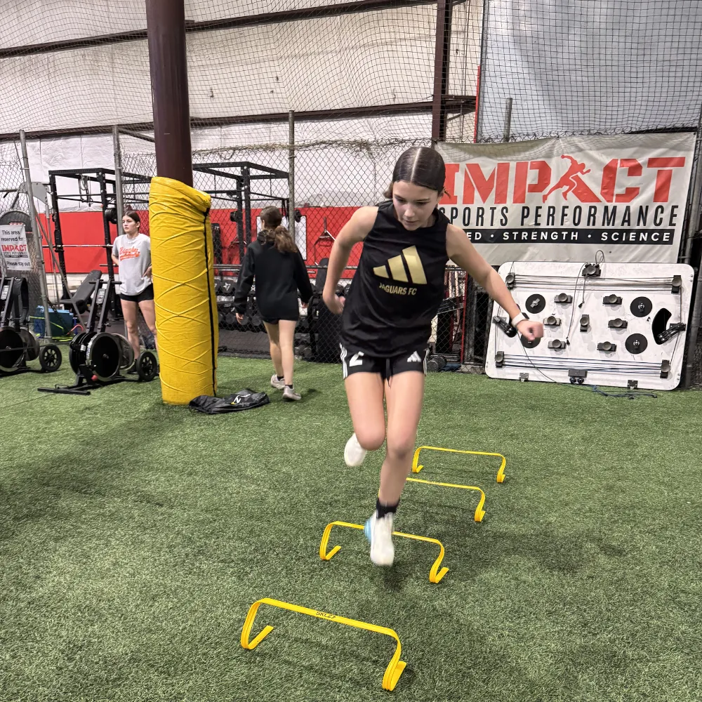 Middle school athlete performing speed drills with Impact Sports Performance coach