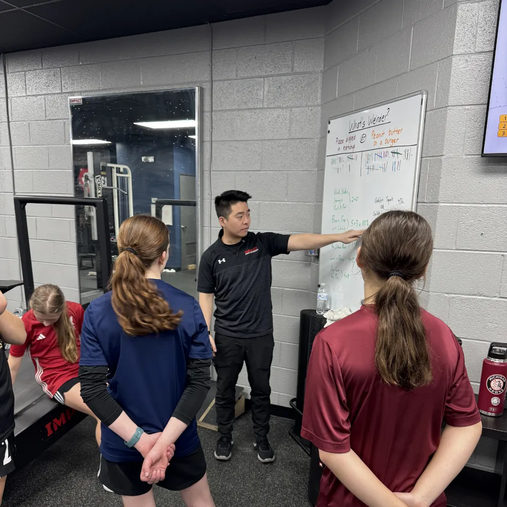 Group of middle school athletes training in small-group session at Impact Sports Performance
