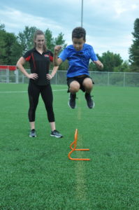 Young athlete performing agility training during youth sports performance program