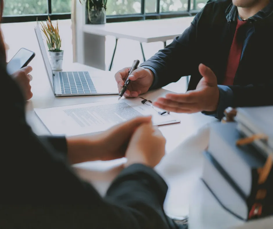 Portrait of logistics consultant Daniel Romero in a navy blazer, arms folded, facing the camera.