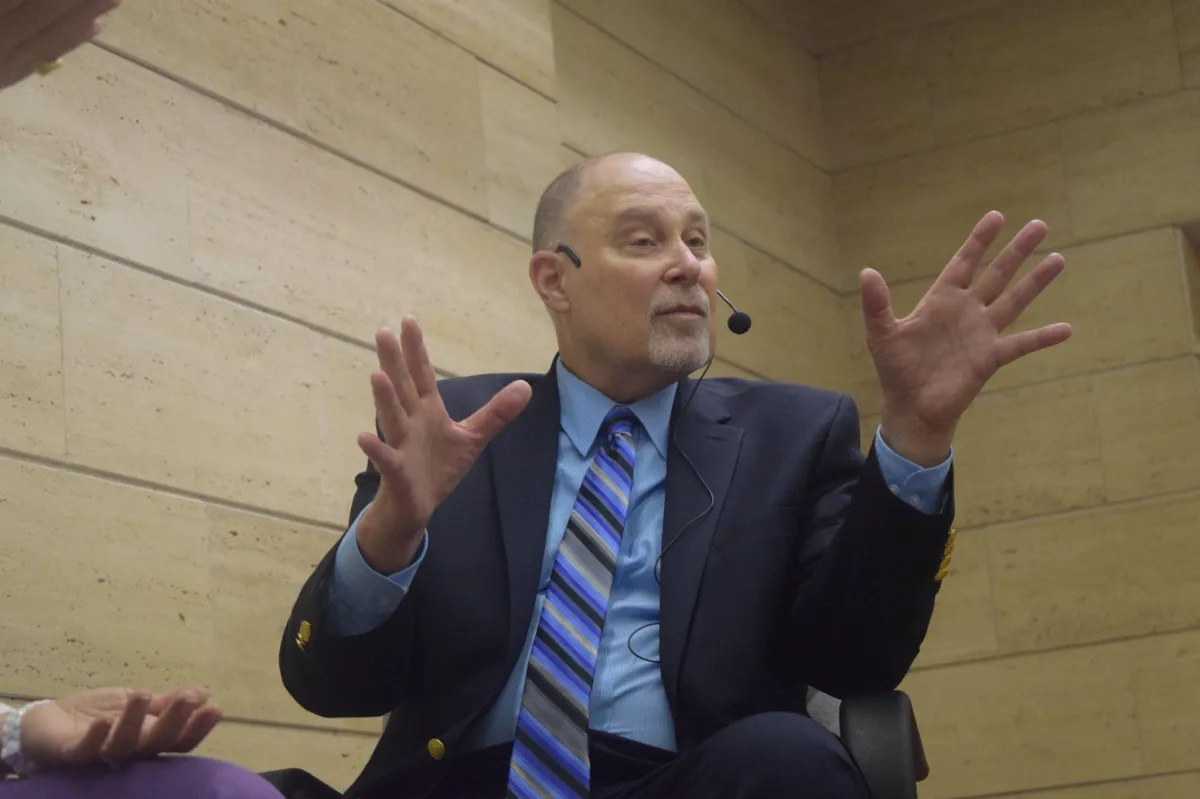 Instructor demonstrating rapid engagement hypnosis technique to a professional cohort