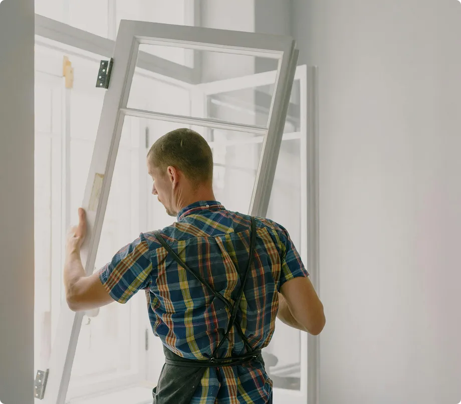 Professional window installer performing expert window replacement in Delaware home