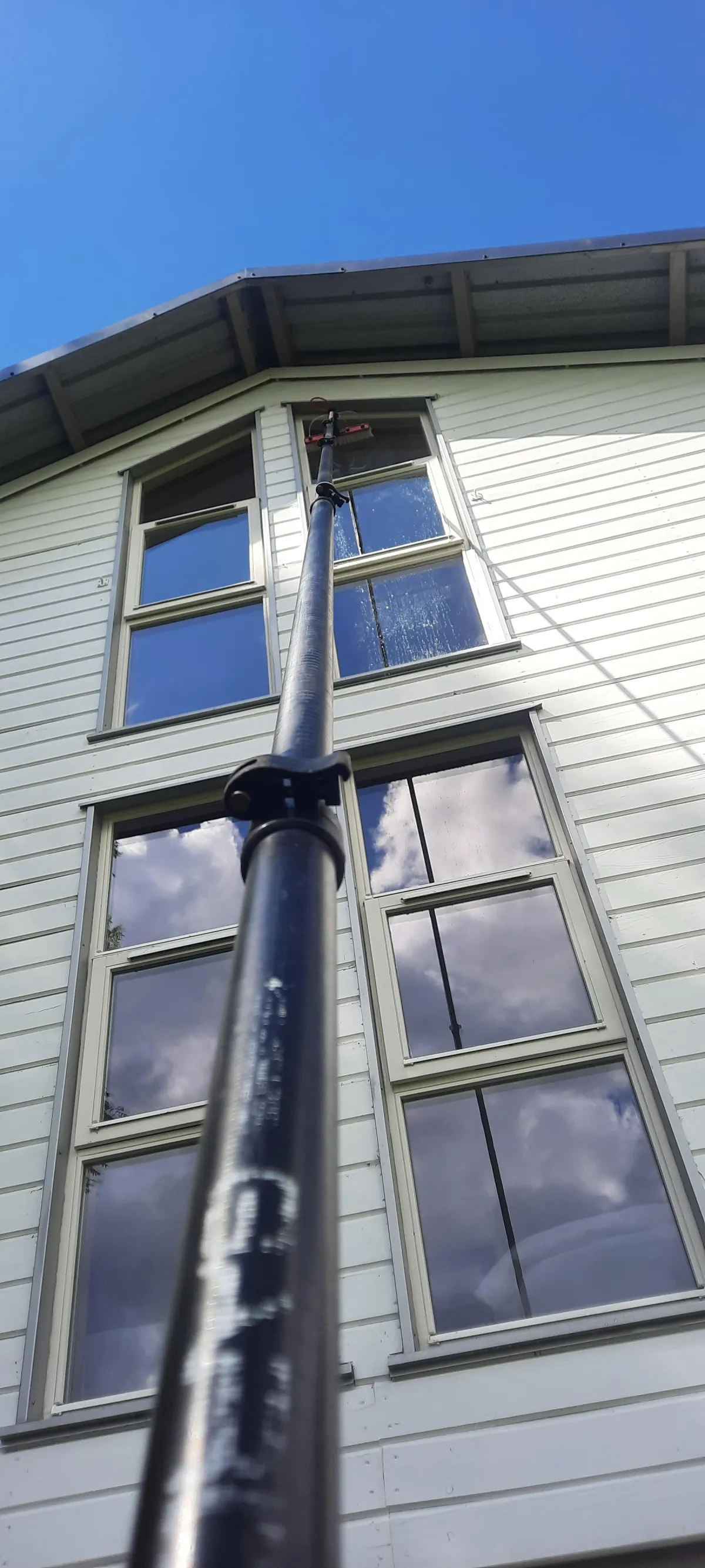 high rise window ceaning using a water fed pole and pure water