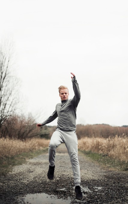 energetic man jumping outdoors, reflecting vitality gained from treatments at an acupuncture clinic in woodbury mn.