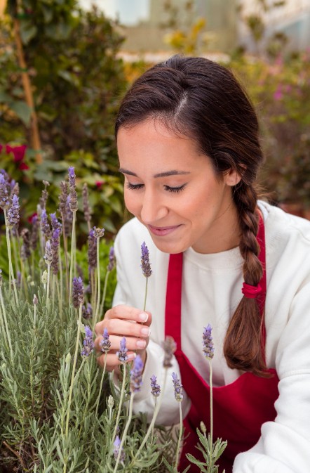 woman smelling fresh lavender, representing the natural focus of a herbal medicine practitioner in woodbury mn.