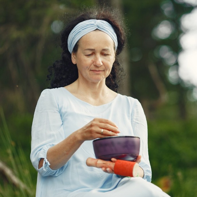 practitioner using a singing bowl during a traditional chinese medicine service at the acupuncture clinic in woodbury mn.