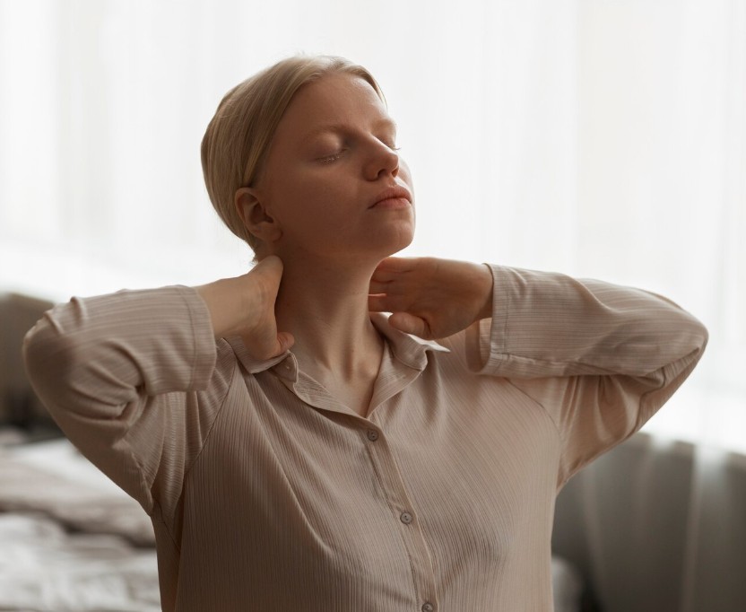 woman gently holding her neck, seeking relief from pain at the acupuncture clinic in woodbury mn.