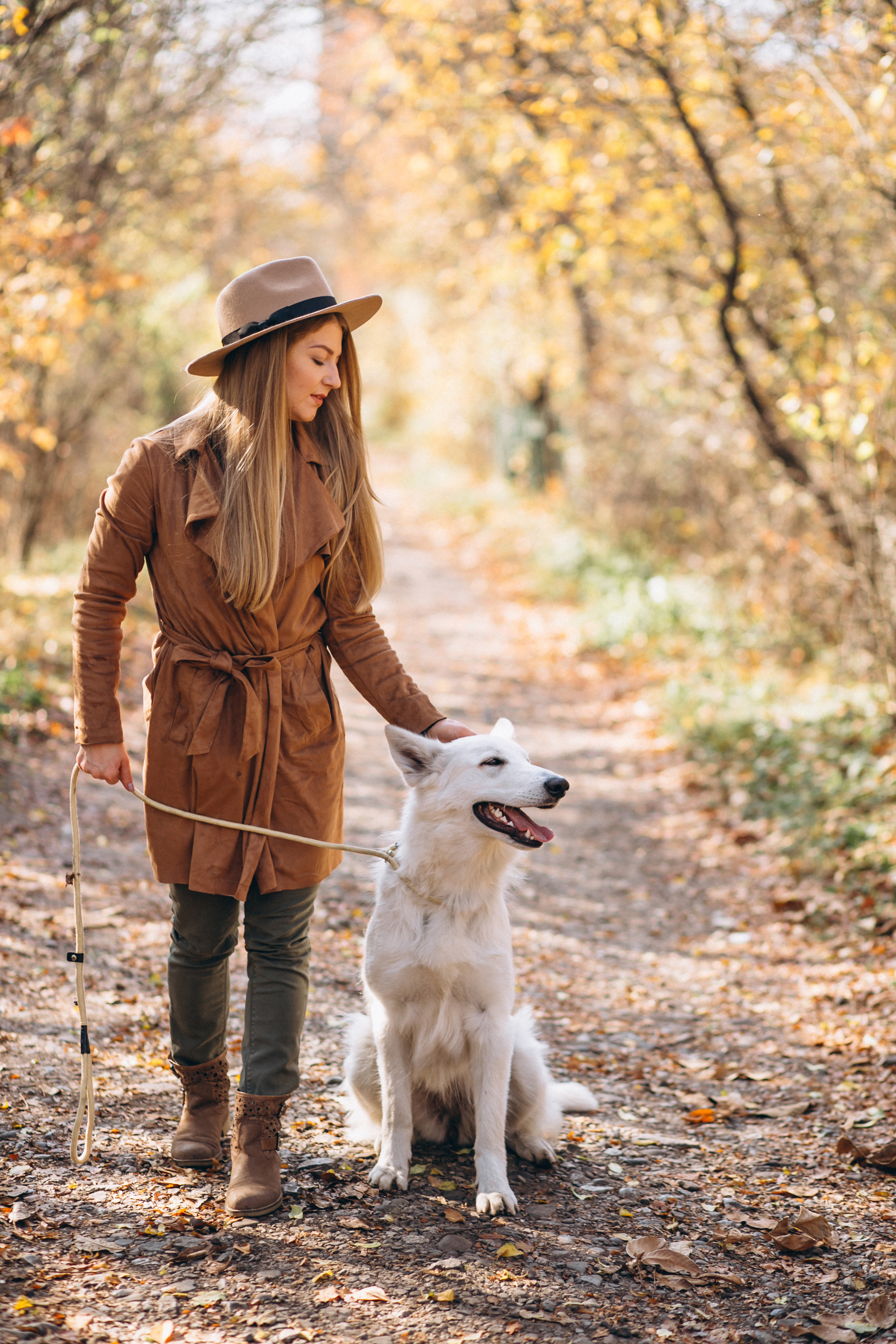 happy woman enjoying a walk in the park with her dog after treatment at a caring acupuncture clinic in woodbury mn.
