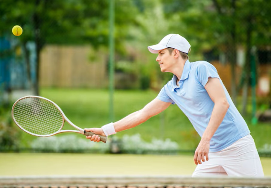 young attractive man play tennis court morning in woodbury mn.