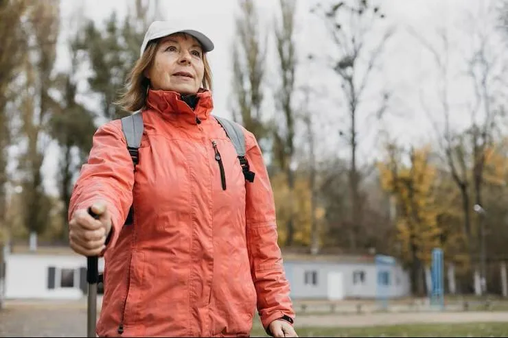 veteran trekking outdoors with a walking stick after successful veterans acupuncture in woodbury mn.