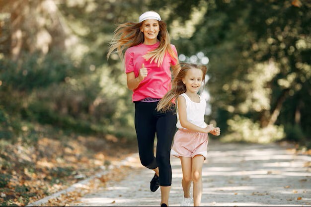 mother and daughter running in park feeling good after visiting a pain control clinic in woodbury mn.