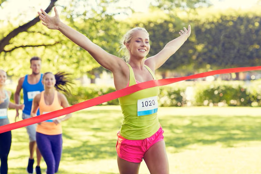 woman crossing a finish line at a race after receiving care at a pain control clinic in woodbury mn.