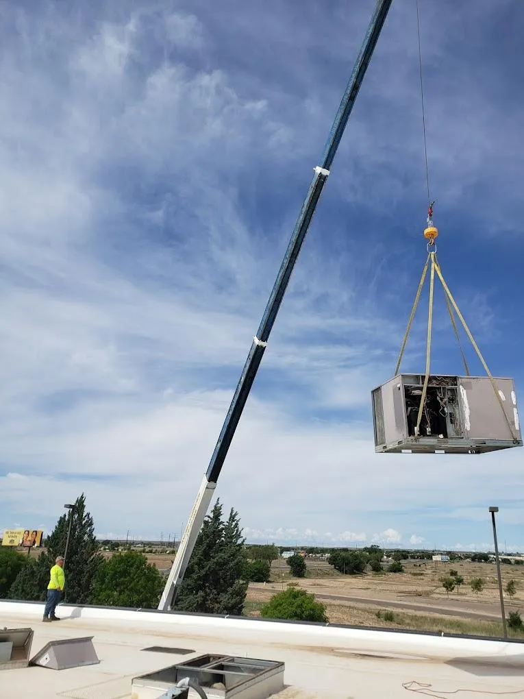 Our team replacing a old HVAC unit on top of a office building with a crane.