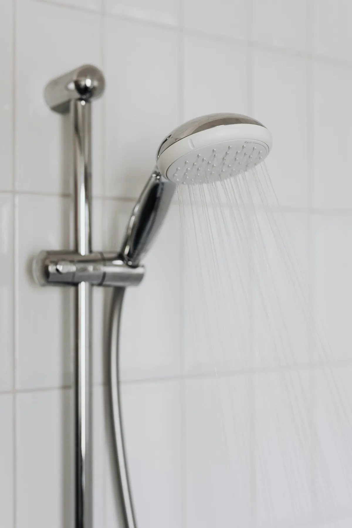 A shower head that is on pouring out water.