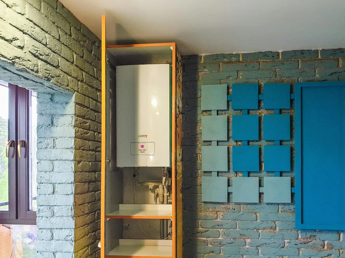 Tankless water heater in the corner of a room.