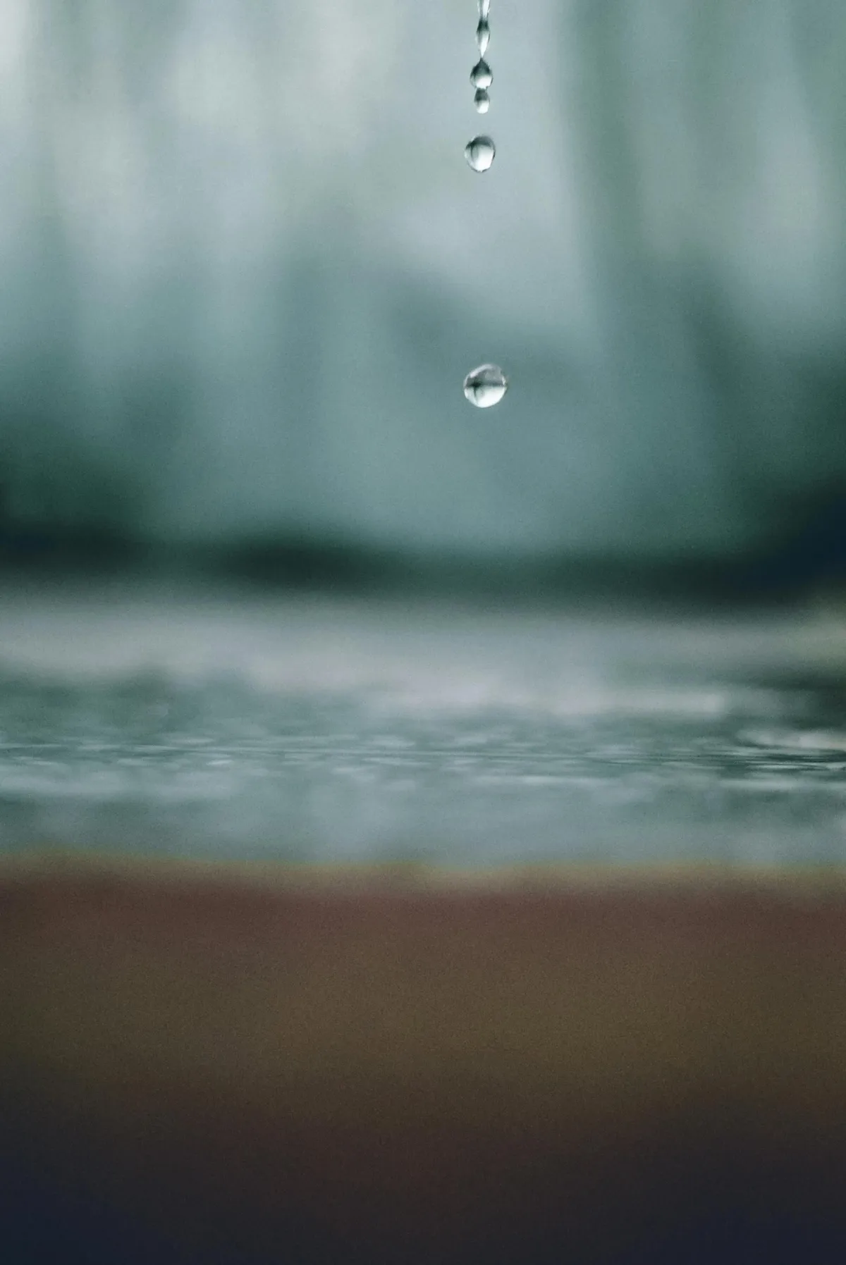 Drops of water falling onto cement floor.