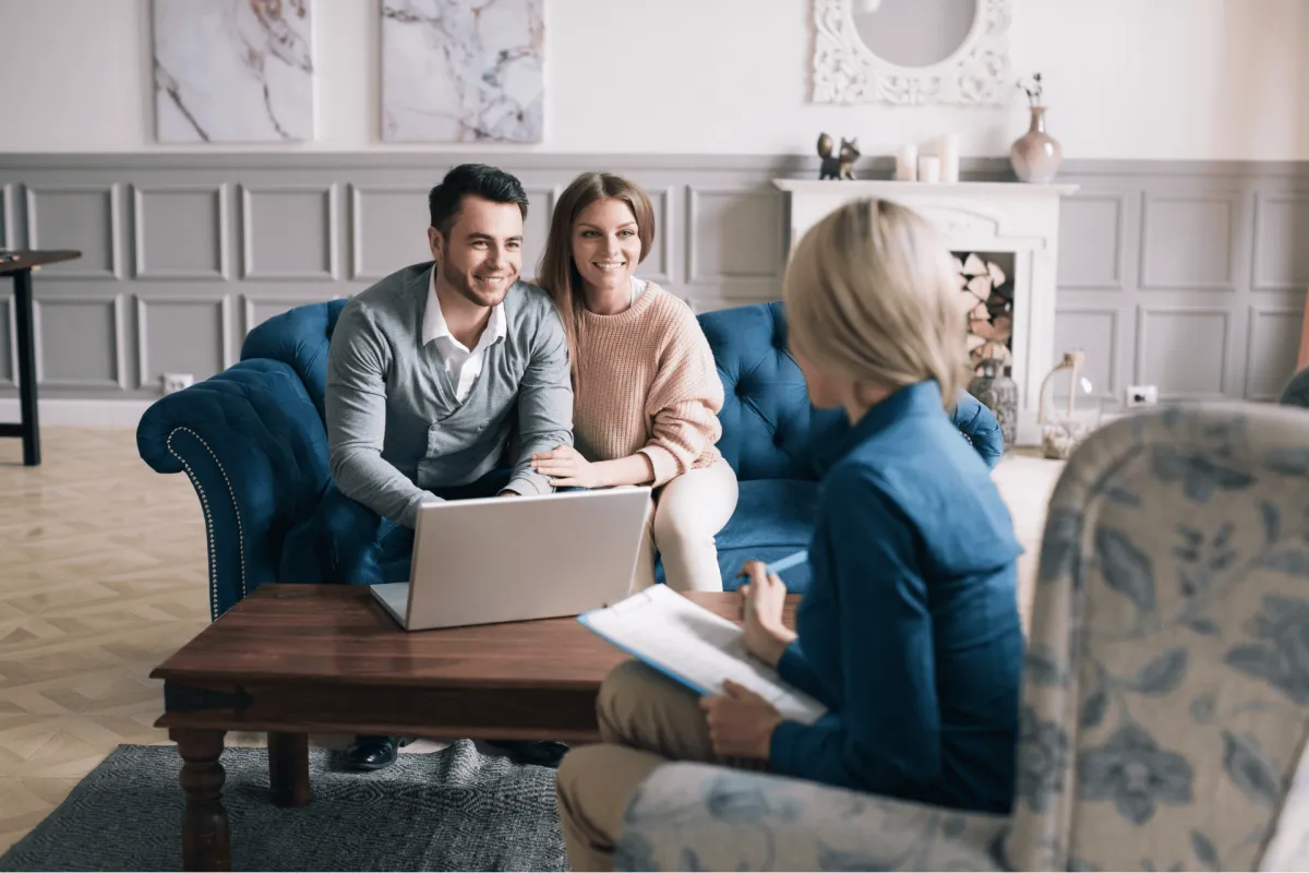 Couple meeting with a financial advisor in a living room