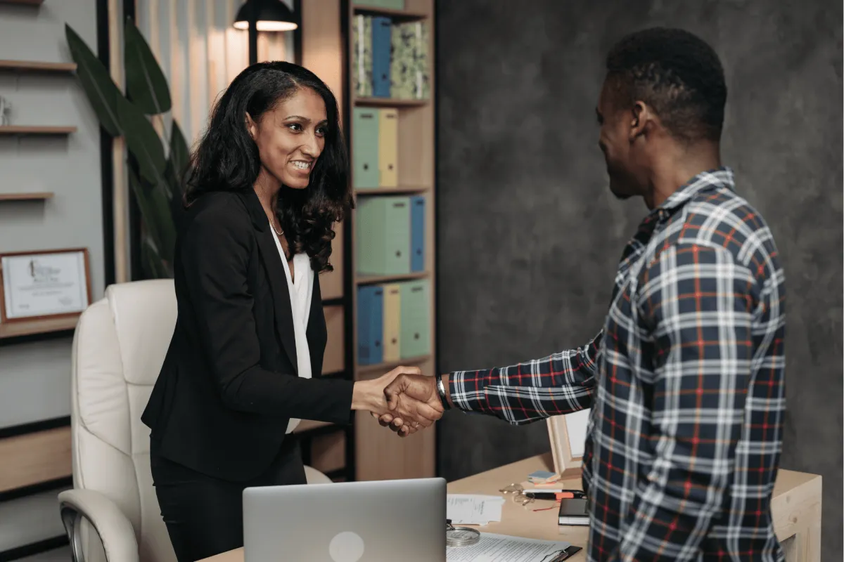 Financial professional shaking hands with a client in an office