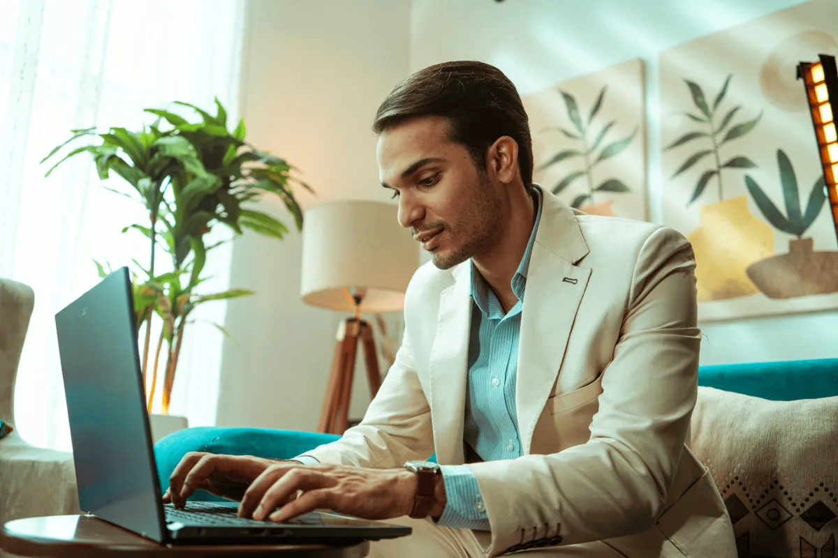 Professional working on a laptop from a living room sofa
