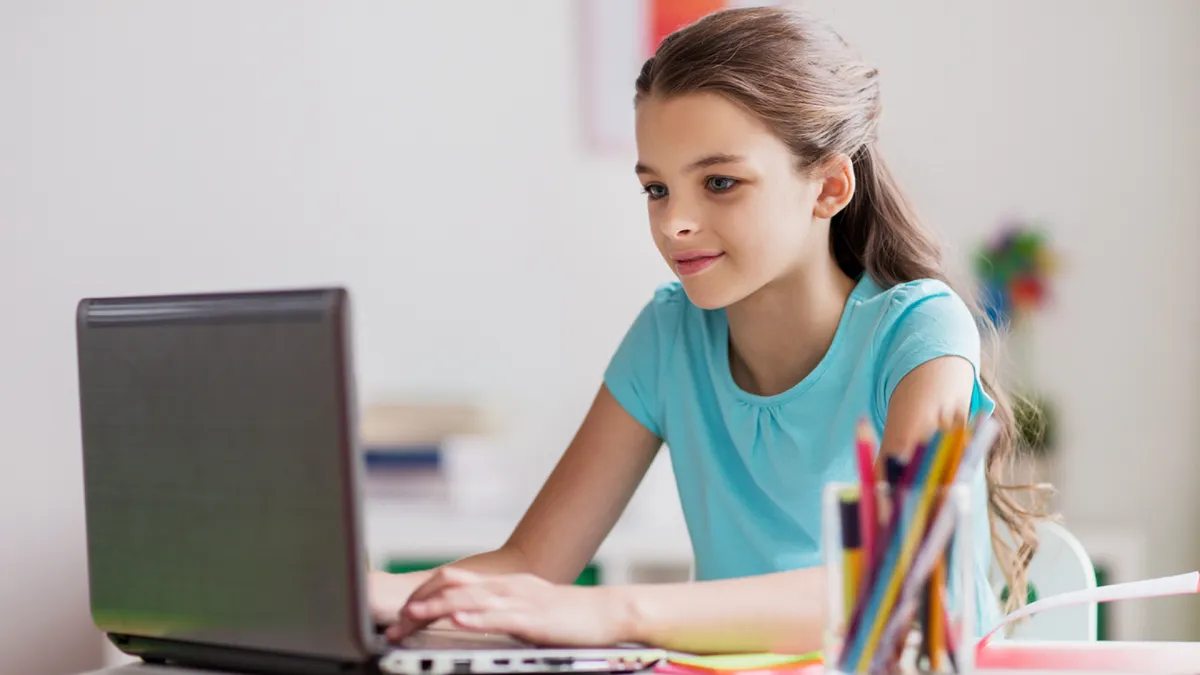 Boy holding a tambourine while watching the teacher on his tablet