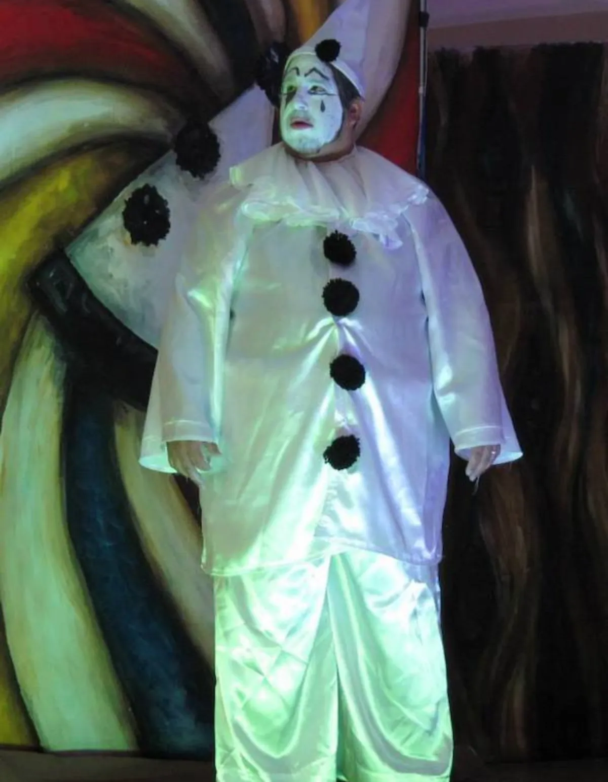 James Nathanel Salazar performing at an elegant private event, surrounded by guests in formal attire, with a string quartet accompanying him in a candlelit hall.