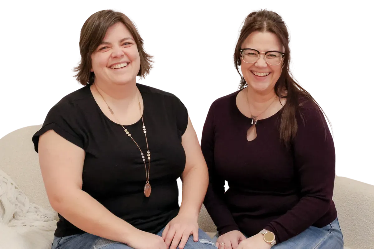 Kim and Kat smiling with raised hands in a casual pose on a transparent background.