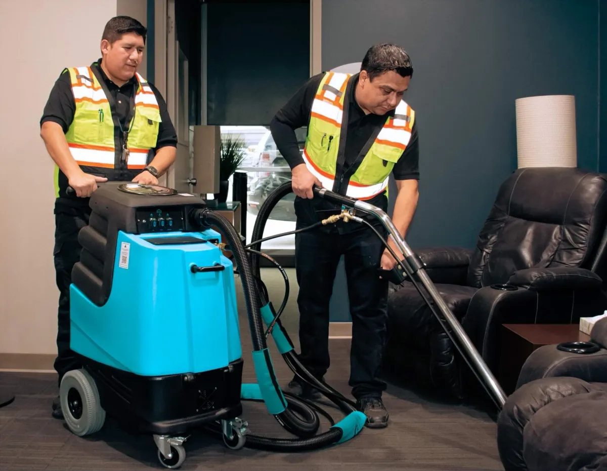 A woman mops a bright, modern living room floor.