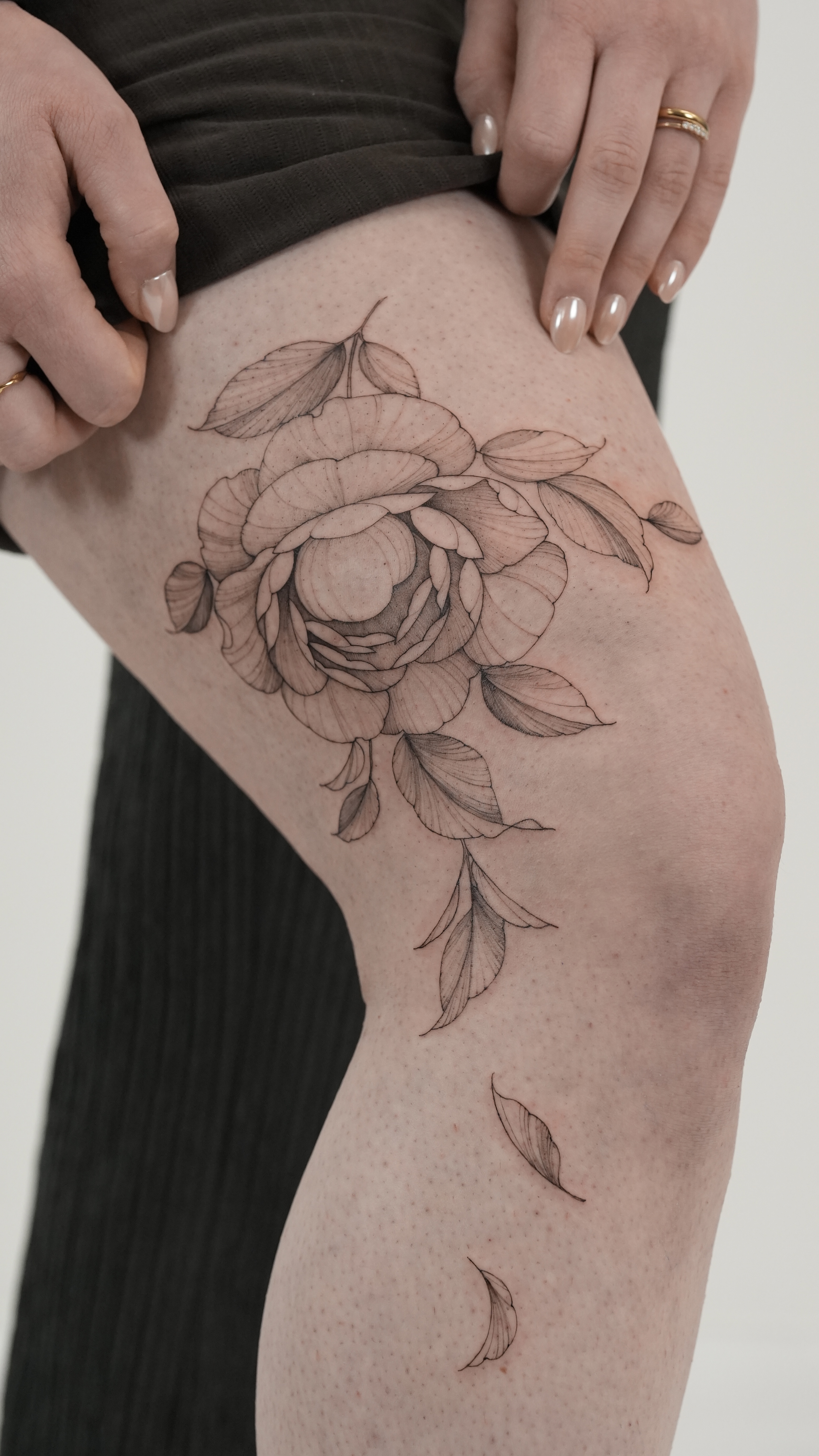 person in blue denim shorts and white nike sneakers standing on gray concrete floor