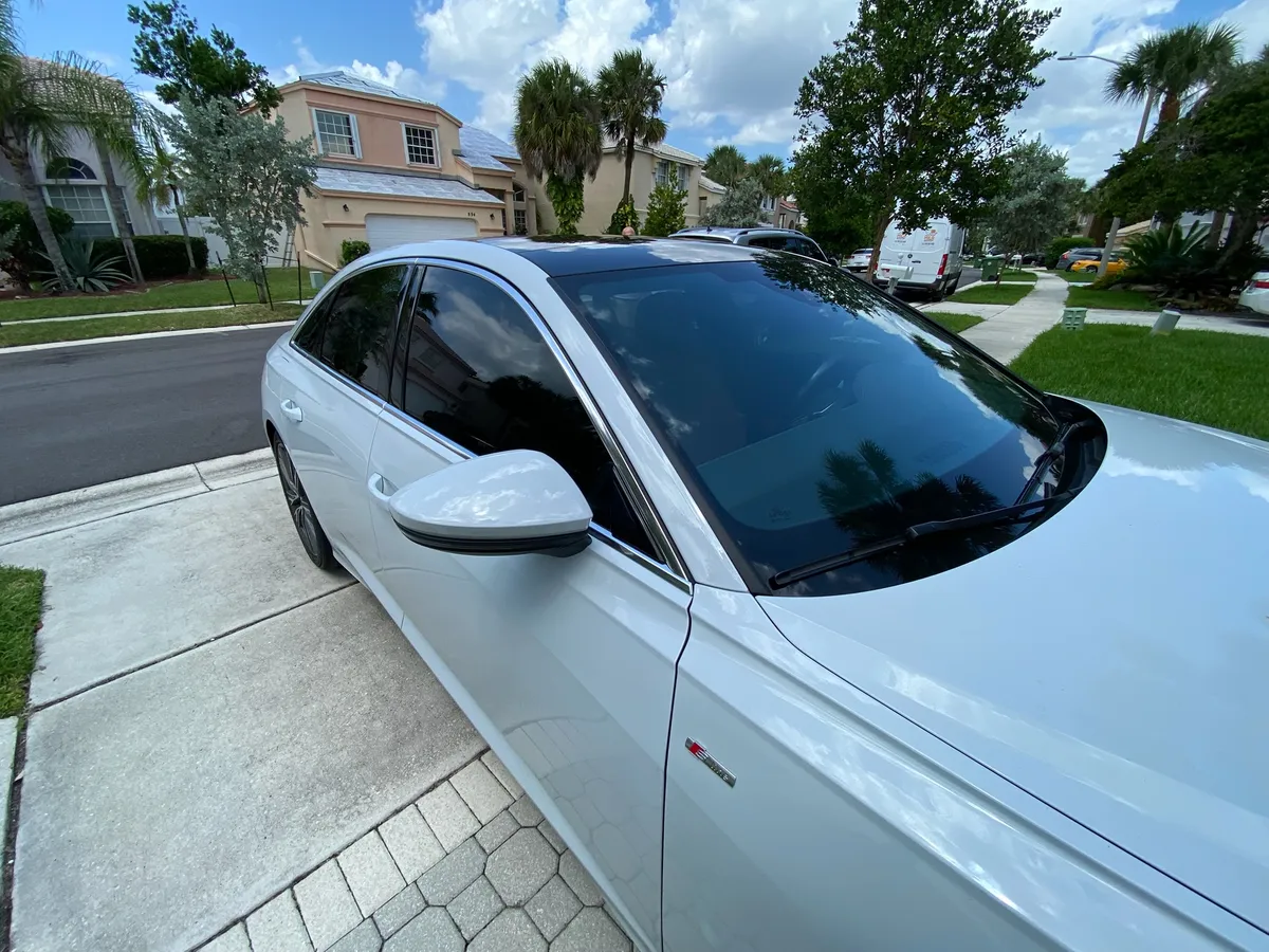 Audi A6 with dark window tint installed at the customer's home
