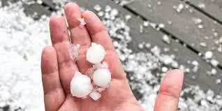 Hail stones in persons hand 