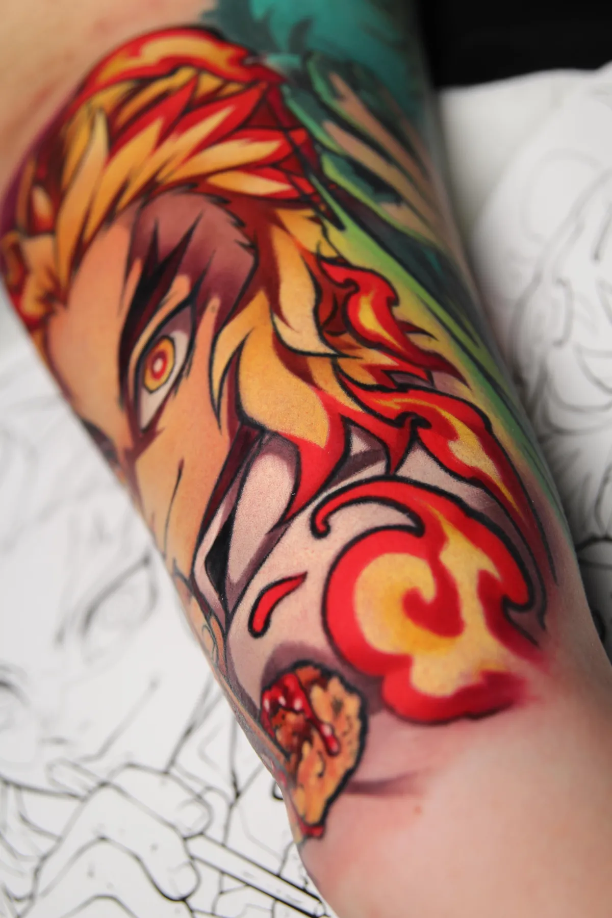 Color anime tattoo of Rengoku from Demon Slayer by Orlando Anime Tattoo Artist Ren Behan. This Rengoku tattoo captures his "umai" moment from the Mugen Train Arc in vibrant color.