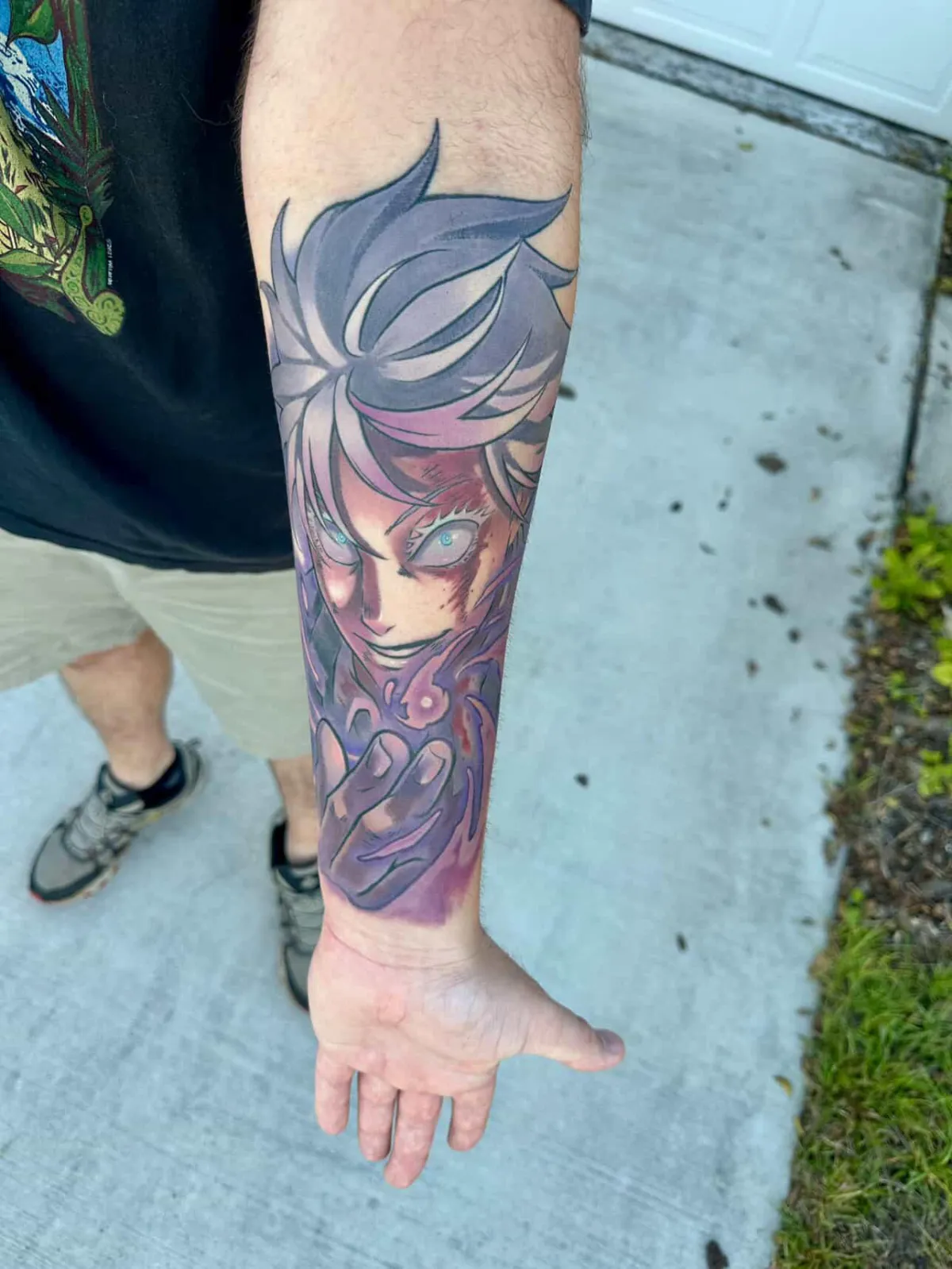 Full healed anime tattoo of Gojo from Jujutsu Kaisen by Orlando Anime Tattoo Artist Ren Behan. This tattoo of Gojo uses a high contrast color composition with vivid purples and grays to capture his hollow purple attack.