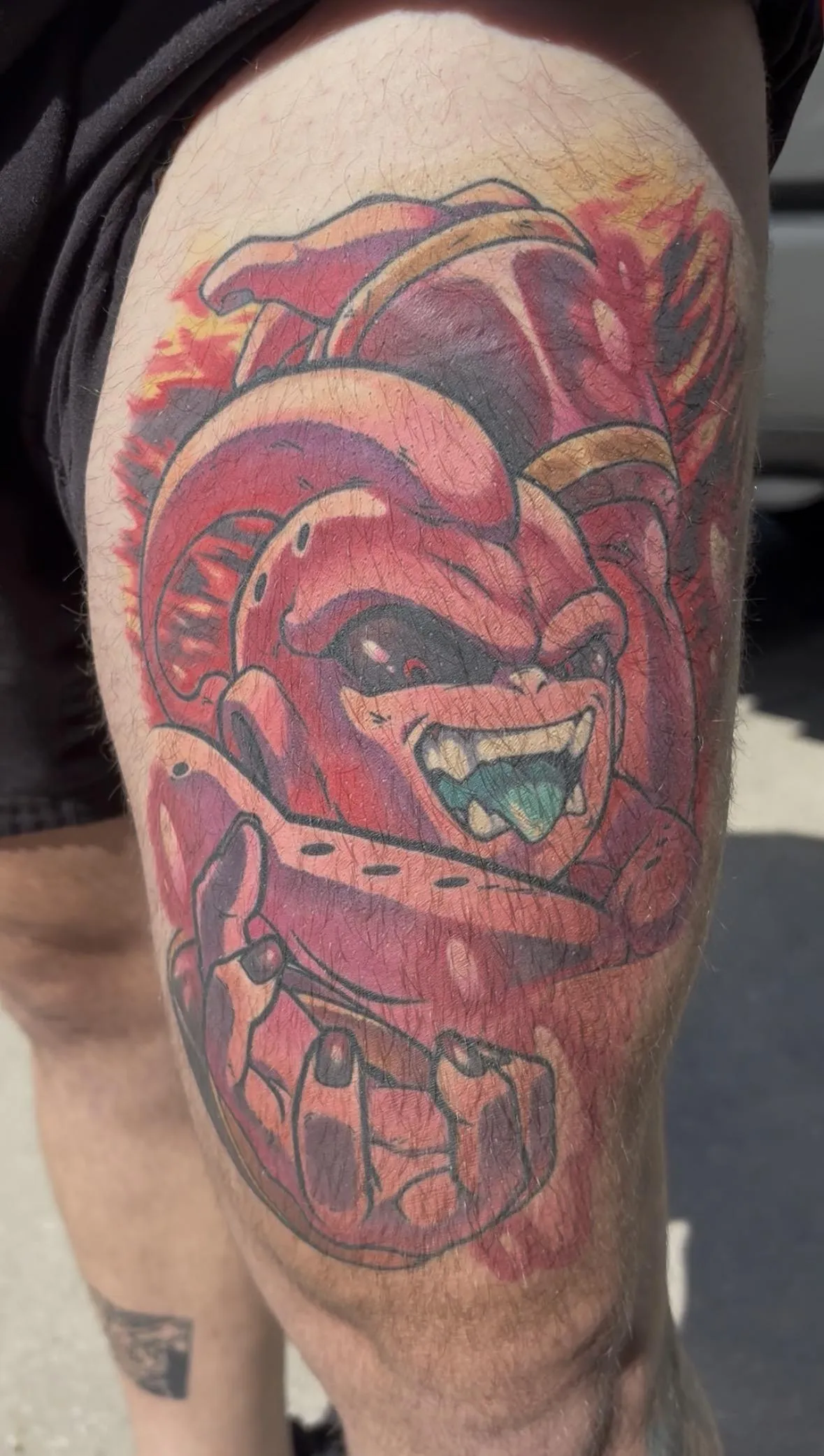 Fully healed anime tattoo of Kid Buu from DBZ by Orlando Anime Tattoo Artist Ren Behan. This DBZ tattoo has striking pinks and bright yellows even after the heal.