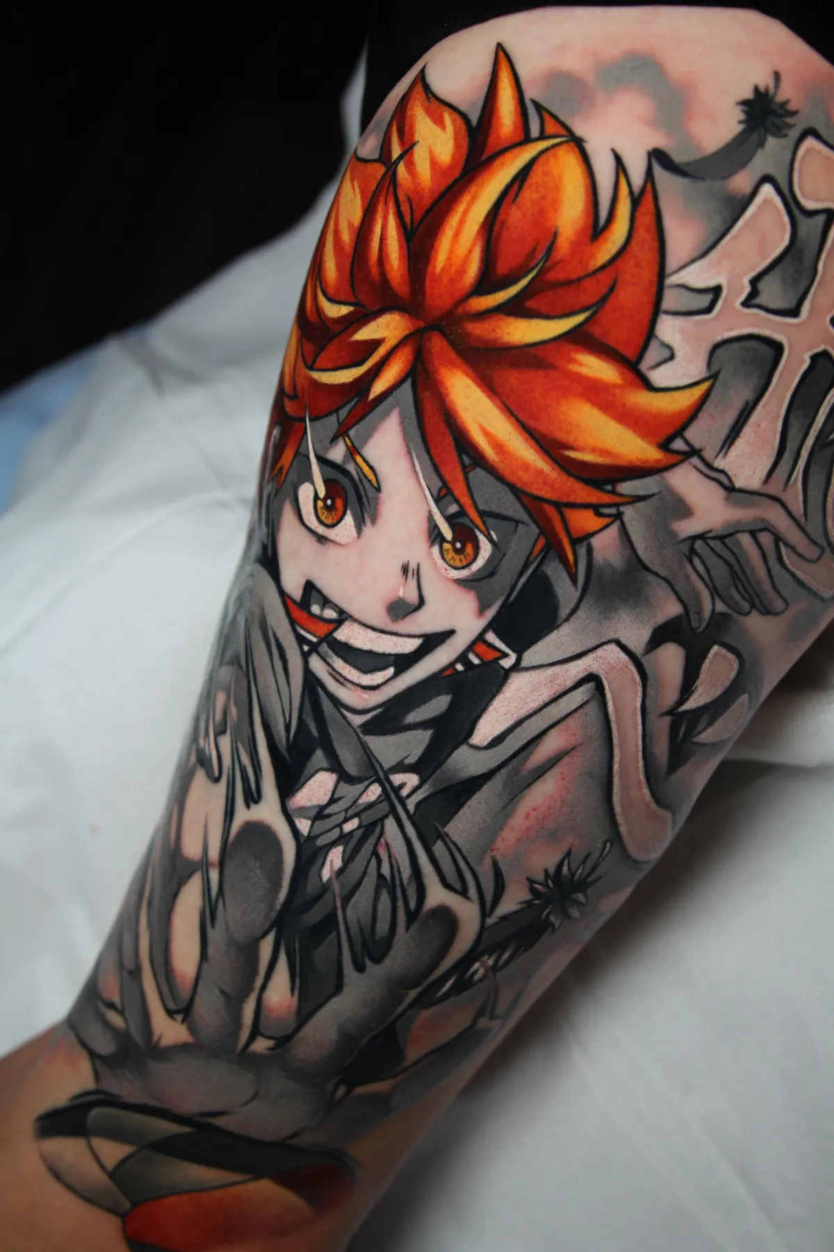 Black and Gray anime tattoo with color accents of Shoyo from Haikyu by Orlando Anime Tattoo Artist Ren Behan.