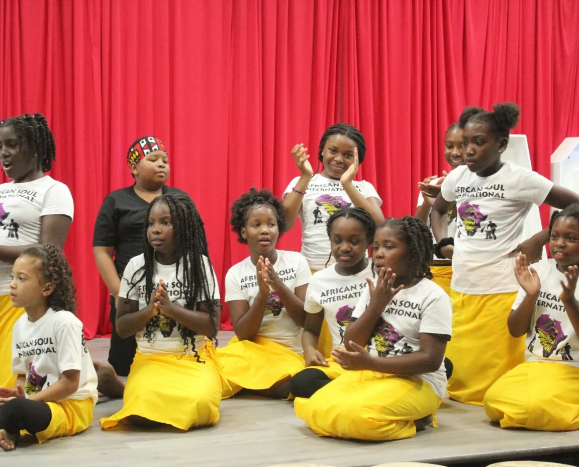 Youth participating in African cultural dance and djembe drumming during workshop