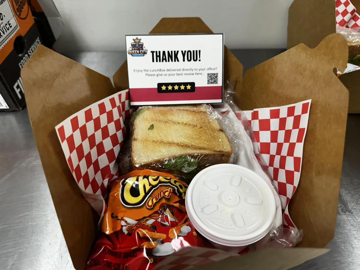 BLT open box blt with  BLT sandwich cheetos potato salad and a thank you card