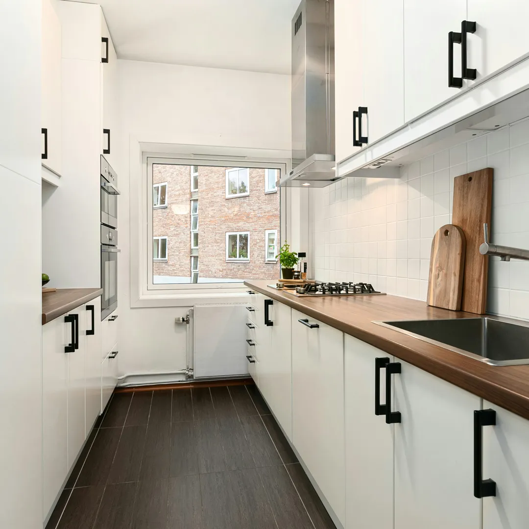 Hand holding an NYC Department of Buildings work permit, representing licensed remodeling and full permit handling by Home Design & Co.