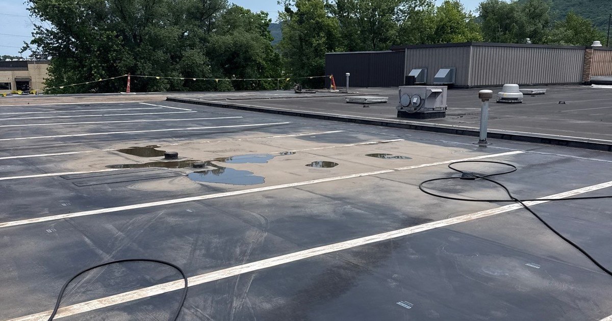 Ponding water on a low-slope EPDM commercial roof in Central Pennsylvania