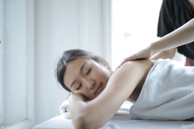 a person lying on a massage table