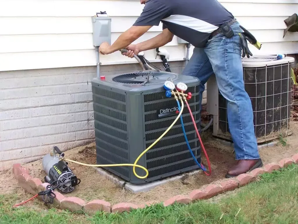 a person working on a air conditioner