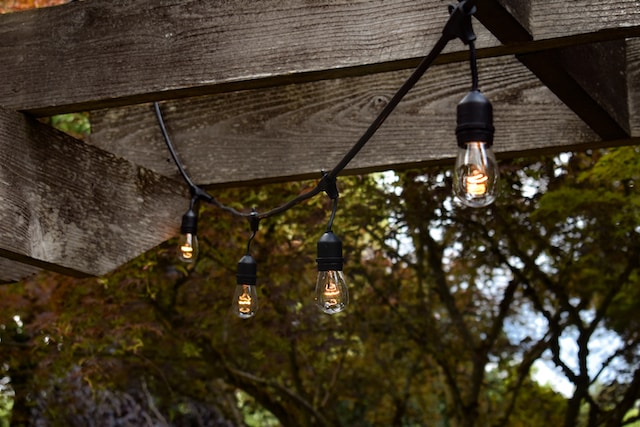 a string of lights on a wooden structure