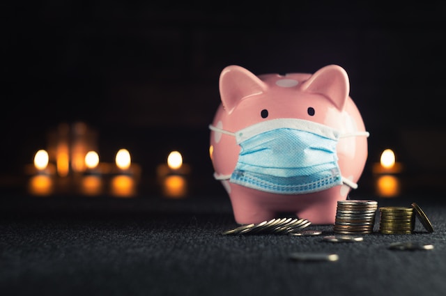 a piggy bank wearing a face mask and coins