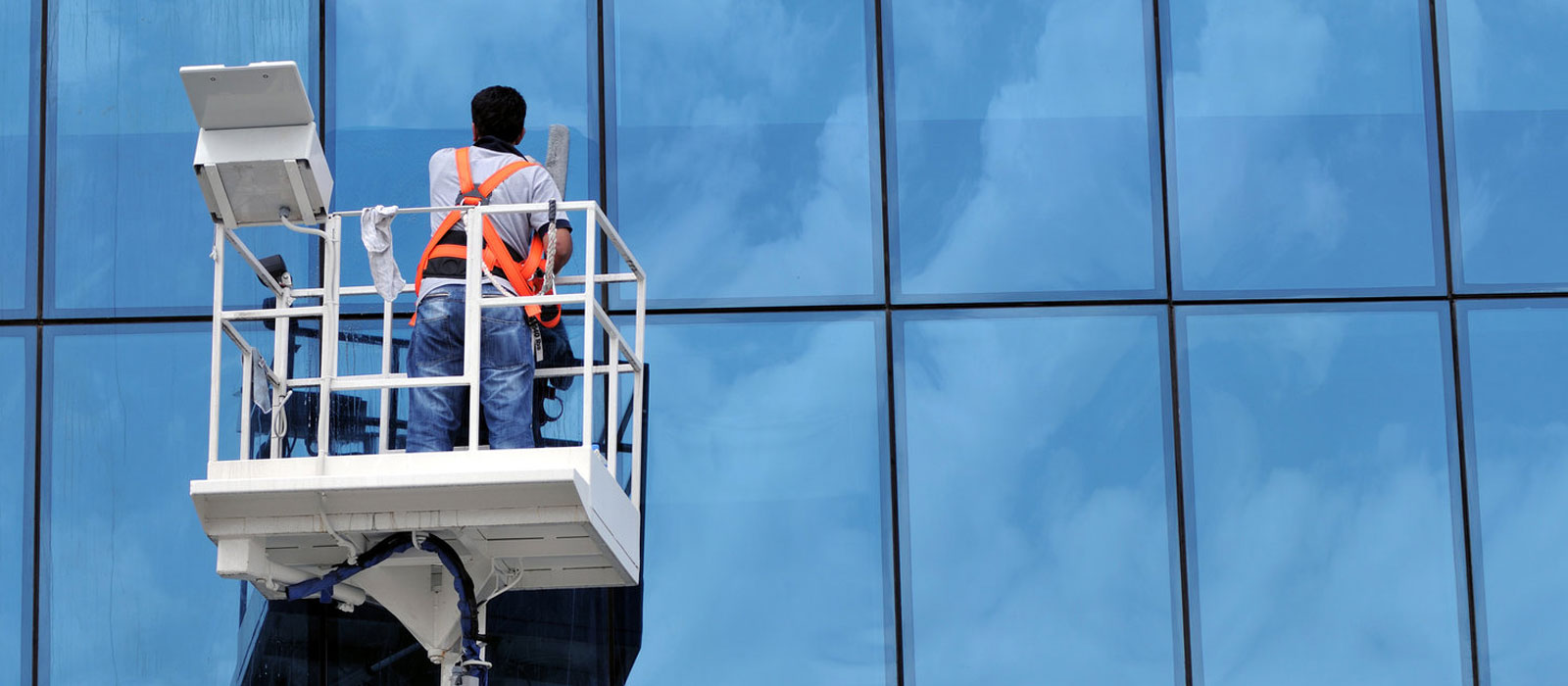 a person on a lift with a window washer