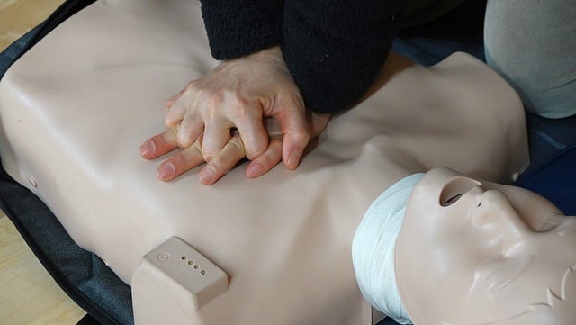 a person's hands on a dummy for cpr