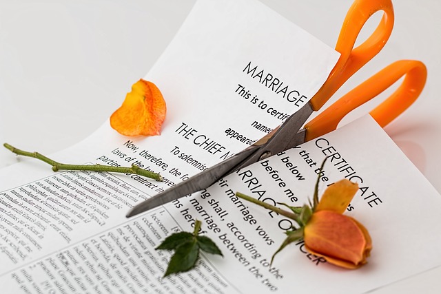 a pair of scissors cutting a marriage document