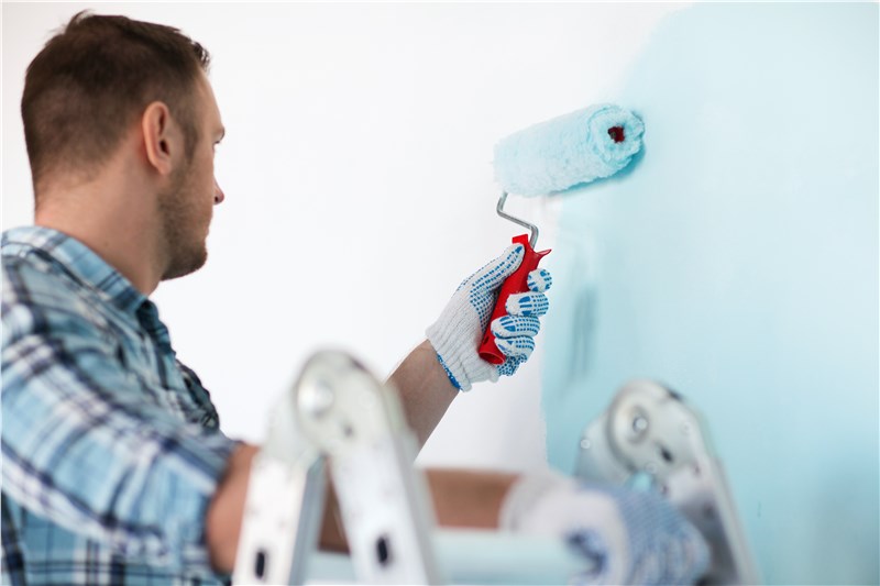 a person painting a wall