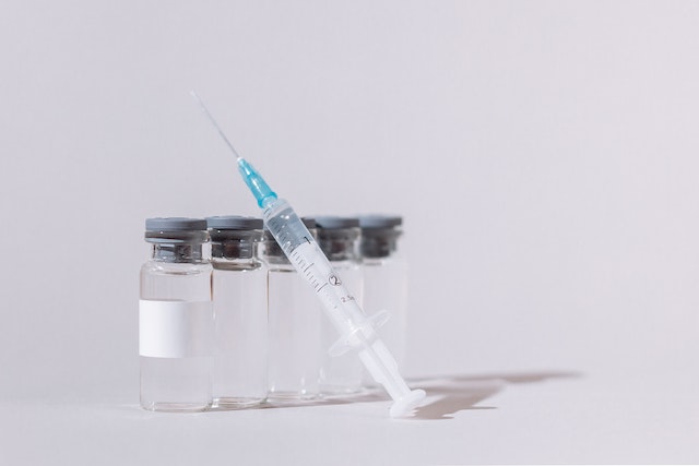 a syringe and vials of liquid