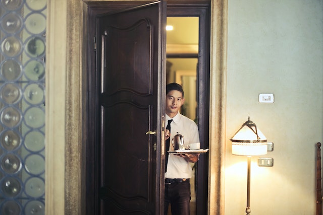 a person holding a tray of tea and a cup